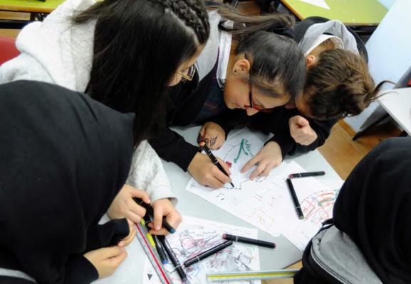 Girls working on designing a school